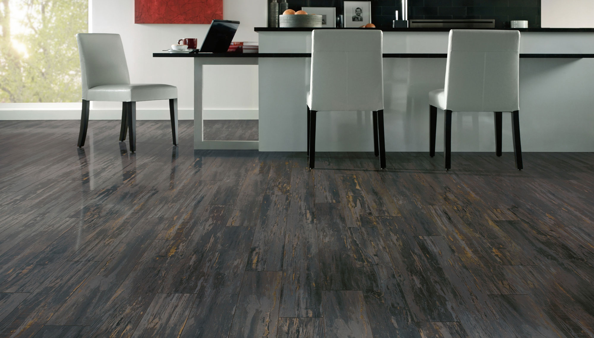 Complete Modern Kitchen with White Chairs and Long Island near Black Backsplash above Laminate Wood Flooring